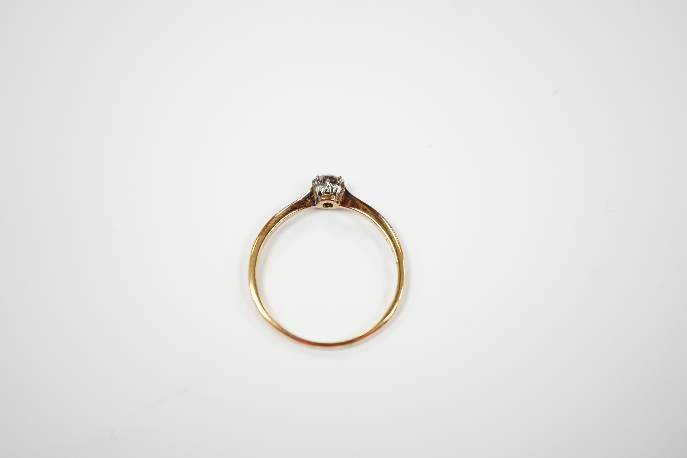 A yellow metal and solitaire diamond set ring, size V, gross weight 2 grams.